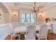 Dining room with neutral paint, wainscoting, and classic chandelier at 504 Belmont Cir, Wake Forest, NC 27587
