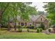 Charming brick home features a manicured lawn and lush landscaping with a welcoming front porch at 504 Belmont Cir, Wake Forest, NC 27587
