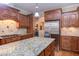 Kitchen featuring stainless steel appliances, wooden cabinets and large center island with granite countertops at 504 Belmont Cir, Wake Forest, NC 27587