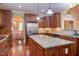 This kitchen features wood cabinets, stainless steel appliances, and an island with granite counters at 504 Belmont Cir, Wake Forest, NC 27587