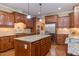Gourmet kitchen with granite countertops, stainless steel appliances, and custom cabinetry, perfect for cooking at 504 Belmont Cir, Wake Forest, NC 27587