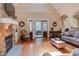 Sunlit living room with stone fireplace, built-in shelves, and hardwood floors, for relaxation and entertainment at 504 Belmont Cir, Wake Forest, NC 27587