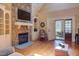 Cozy living room with stone fireplace, built-in shelves, and French doors to outdoor space at 504 Belmont Cir, Wake Forest, NC 27587