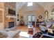 Bright living room with stone fireplace, built-in shelves, and hardwood floors, perfect for gatherings at 504 Belmont Cir, Wake Forest, NC 27587