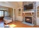 Spacious living room featuring a stone fireplace, hardwood floors, and built-in shelving at 504 Belmont Cir, Wake Forest, NC 27587