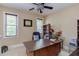 Functional home office with a large desk, ample natural light, and cozy chair, creating an efficient workspace at 504 Belmont Cir, Wake Forest, NC 27587