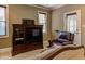 This sitting area features a TV, leather chair, and access to a screened porch at 504 Belmont Cir, Wake Forest, NC 27587