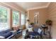 Relaxing sunroom filled with sunlight, comfortable seating, and a grill at 504 Belmont Cir, Wake Forest, NC 27587