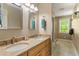Double vanity bathroom with granite countertops, light wood cabinets, undermount sinks, and modern lighting at 504 S Dixon Ave, Cary, NC 27511
