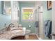 Bathroom with granite countertop, white cabinets, and a glass-enclosed shower with marble tiles at 504 S Dixon Ave, Cary, NC 27511