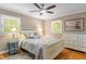 Cozy bedroom with natural light, a ceiling fan, and a white wooden bed frame at 504 S Dixon Ave, Cary, NC 27511