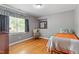 Cozy bedroom featuring hardwood floors and natural light streaming through the window at 504 S Dixon Ave, Cary, NC 27511