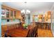 Spacious dining room with a built-in desk area, hardwood floors, and an open layout to the kitchen at 504 S Dixon Ave, Cary, NC 27511