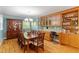 Dining room featuring a large table, wooden floors, and built-in cabinets with display shelves at 504 S Dixon Ave, Cary, NC 27511