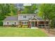 Charming two-story home with a brick facade, well-manicured lawn, and inviting front porch at 504 S Dixon Ave, Cary, NC 27511