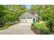 View of a two-car attached garage, long driveway, and landscaped front yard of home at 504 S Dixon Ave, Cary, NC 27511