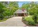 Long driveway leads to a house featuring a covered carport and well-manicured landscaping at 504 S Dixon Ave, Cary, NC 27511