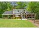 Charming two-story home with a brick facade, beautiful landscaping, and a welcoming front porch at 504 S Dixon Ave, Cary, NC 27511