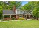 Inviting two-story home featuring a classic brick exterior, well-manicured lawn, and covered front porch at 504 S Dixon Ave, Cary, NC 27511