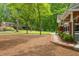 Front yard with pine straw and landscaping leading to a home exterior featuring brick and a covered porch at 504 S Dixon Ave, Cary, NC 27511