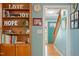 Bright hallway with hardwood floors, built-in shelving, and a glimpse of the front door and staircase at 504 S Dixon Ave, Cary, NC 27511
