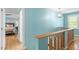 Upstairs hallway with hardwood floors and view into the bedroom at 504 S Dixon Ave, Cary, NC 27511