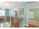 Upstairs hallway with hardwood floors, decorative lighting, and views into bedrooms at 504 S Dixon Ave, Cary, NC 27511