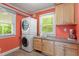 Functional laundry room featuring a stacked washer and dryer, counter space, and ample storage at 504 S Dixon Ave, Cary, NC 27511