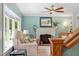 Cozy living room featuring a fireplace, ceiling fan, and plenty of natural light from the bay window at 504 S Dixon Ave, Cary, NC 27511