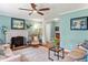 Inviting living room with a fireplace, ceiling fan, and views to the entry and the adjacent dining area at 504 S Dixon Ave, Cary, NC 27511