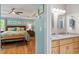 Inviting main bedroom with hardwood floors, ceiling fan, en suite, and bench at the foot of the bed at 504 S Dixon Ave, Cary, NC 27511