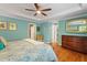 This main bedroom with hardwood floors boasts an ensuite, ceiling fan, and ample closet space at 504 S Dixon Ave, Cary, NC 27511