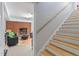 Basement staircase leading to a room with fireplace, a sofa, and colorful accents at 504 S Dixon Ave, Cary, NC 27511