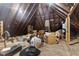 Spacious attic featuring exposed wooden beams, brick chimney, and ample storage space at 517 N East St, Raleigh, NC 27604