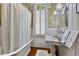 Bright bathroom featuring a clawfoot tub, white beadboard walls, and vintage fixtures, blending comfort and style at 517 N East St, Raleigh, NC 27604