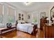 Bedroom with hardwood floors, and warm natural light, wooden furniture and charming decor at 517 N East St, Raleigh, NC 27604