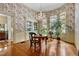 Bright dining room featuring hardwood floors, large windows, and a stylish chandelier at 517 N East St, Raleigh, NC 27604