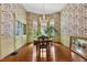 Elegant dining room featuring hardwood floors, natural light, and charming wallpaper at 517 N East St, Raleigh, NC 27604