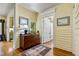Bright entryway featuring hardwood floors, a decorative rug, and an antique cabinet leading to other areas of the home at 517 N East St, Raleigh, NC 27604