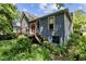 Exterior view of a two-story home with blue siding, red-framed windows, and a wooden deck at 517 N East St, Raleigh, NC 27604