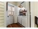Functional laundry room with a washer, dryer, storage shelves, and a door leading outside, maximizing space and convenience at 517 N East St, Raleigh, NC 27604