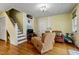 Cozy living room with hardwood floors, stairs, and comfortable seating at 517 N East St, Raleigh, NC 27604