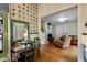 Inviting living room with unique chicken-themed wallpaper and open layout to a cozy seating area, blending charm and comfort at 517 N East St, Raleigh, NC 27604