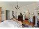 Spacious main bedroom with hardwood floors, vintage furniture, and access to multiple rooms, offering style and functionality at 517 N East St, Raleigh, NC 27604