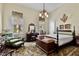Charming main bedroom featuring a four-poster bed, vintage furnishings, and bright windows with decorative valances at 517 N East St, Raleigh, NC 27604
