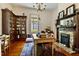 Charming office features hardwood floors, a fireplace, and custom built-in shelving for storage at 517 N East St, Raleigh, NC 27604