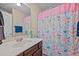 Clean bathroom featuring a white vanity and mirror, with a floral shower curtain at 5321 Longspur Dr, Snow Camp, NC 27349
