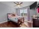 bedroom featuring wood flooring, ceiling fan, lots of natural light, and light purple walls at 5321 Longspur Dr, Snow Camp, NC 27349