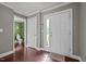 Bright foyer featuring wood flooring, white trim, and a door to the bathroom and doorway to other rooms at 5321 Longspur Dr, Snow Camp, NC 27349