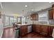 Kitchen featuring stainless steel appliances, recessed lighting, dark cabinets, and dining area with lots of natural light at 5321 Longspur Dr, Snow Camp, NC 27349